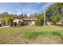 Charming single-story home with a well-maintained lawn and mature landscaping in a quiet neighborhood at 12250 Lacey Dr, New Port Richey, FL 34654