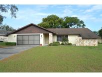 Charming single Gathering home featuring a two-car garage and quaint stone accents at 13425 Bonita Ave, Spring Hill, FL 34609