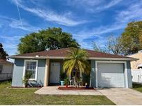 Charming single-story home featuring a well-maintained lawn, attached garage, and a welcoming front entrance at 3315 W Saint John St, Tampa, FL 33607