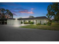 Charming single-story home with lush landscaping and a covered carport offers an inviting curb appeal at 3544 Teeside Dr # 1, New Port Richey, FL 34655