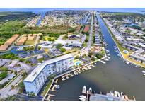 High-angle view of waterfront condo, marina, and coastal neighborhood, showing waterways and community amenities at 4939 Floramar Ter # 204, New Port Richey, FL 34652