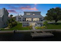 Stunning waterfront home featuring a metal roof, lush landscaping, and a private boat dock at 5234 Foxhall Ct, Weeki Wachee, FL 34607