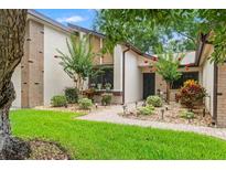Charming single-story home with a well-manicured lawn, garden beds, and a brick pathway leading to the front entrance at 7512 Heather Walk Dr, Weeki Wachee, FL 34613