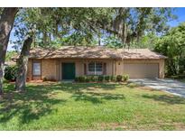 Charming single-story home featuring a well-maintained lawn and a covered front porch entrance at 8431 Spring Hill Dr, Spring Hill, FL 34608