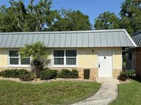Charming single-story home with well-maintained landscaping and a metal roof at 11911 Bayonet Ln, New Port Richey, FL 34654