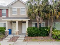 Charming townhome with manicured landscaping and welcoming entrance featuring a stone facade and freshly painted doors at 12408 Country White Cir, Tampa, FL 33635
