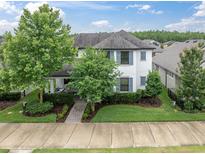 Charming two-story home with manicured lawn, landscaping and a covered front porch at 12854 Rangeland Blvd, Odessa, FL 33556