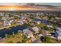 Gorgeous aerial view of waterfront homes with boat docks on canals leading to the ocean at sunset at 3546 Flamingo Blvd, Hernando Beach, FL 34607