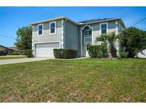Charming two-story home featuring a well-manicured lawn and attached two-car garage at 8388 Maltby Rd, Spring Hill, FL 34606