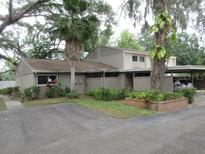 Inviting single-story home featuring a covered carport and well-maintained landscaping at 8640 Lake Isle Dr # 188, Temple Terrace, FL 33637