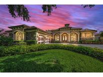 Stunning home features a manicured lawn, stone accents, and a three-car garage at 9933 Milano Dr, Trinity, FL 34655