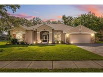 Charming single-story home featuring a well-manicured lawn and inviting facade at 10296 Palmgren, Spring Hill, FL 34608