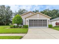 Charming single-Gathering home features a well-manicured lawn and a two-car garage in a quiet neighborhood at 11158 Heathrow Ave, Spring Hill, FL 34609