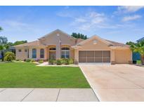 Charming single-story home featuring a well-maintained lawn and a spacious two-car garage at 13155 Cori Loop, Spring Hill, FL 34609