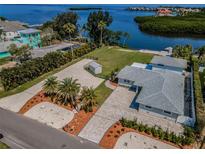 Stunning waterfront property with lush landscaping and a private beach at 1620 Sea Breeze Dr, Tarpon Springs, FL 34689