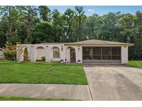 Charming single-story home with a well-manicured lawn and unique arched entryway at 4424 Whitetail Ln, New Port Richey, FL 34653