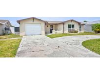 Charming single-story home with a one-car garage and a long driveway in a sunny location at 6231 Westport Dr, Port Richey, FL 34668