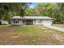 Charming one-story home with a well-manicured lawn and a gray exterior at 7340 20Th, Zephyrhills, FL 33540