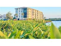 Beautiful exterior view of a waterfront condo building with lush greenery at 8211 Brent St # 836, Port Richey, FL 34668