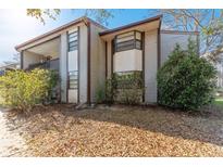 Charming two-story townhouse featuring neutral siding and well-maintained landscaping at 12155 Environmental Dr # 8, New Port Richey, FL 34654