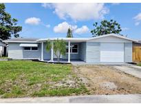 Charming single-story home with a well-maintained lawn and an attached garage, perfect for first-time buyers at 2051 Peggy Dr, Holiday, FL 34690