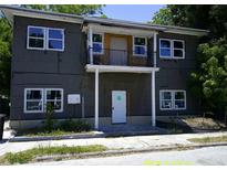 Two story home showing front door and balcony, the exterior shows signs of current renovation at 2914 N 17Th St, Tampa, FL 33605