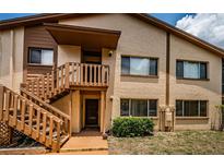 Charming two-story condo with wood stairs leading to the front door and a well-maintained lawn at 3838 Lanyard Ct # 3838, New Port Richey, FL 34652