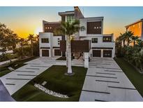 Stunning modern home boasting meticulous landscaping, multi-car garage, and distinctive architectural details at 4333 Harborpointe Dr, Port Richey, FL 34668