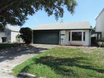 Cozy single-story home with a well-maintained lawn, a two-car garage, and mature shade trees at 4529 Keelboat Pl, New Port Richey, FL 34652