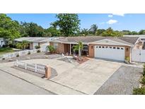Charming single-story home with a well-manicured front yard, circular driveway and attached two car garage at 5330 Dove Dr, New Port Richey, FL 34652