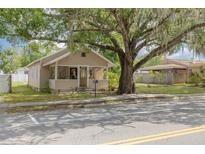 Charming bungalow with a welcoming front porch and mature tree, offering shade and curb appeal at 6207 Main St, New Port Richey, FL 34653