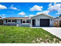 Charming home featuring a one-car garage, well-maintained lawn and fresh exterior paint at 6306 Aberdeen Ave, New Port Richey, FL 34653
