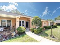 Charming single-story villa with well-maintained landscaping, walkway, and inviting entrance at 9334 Whitstone Ct, New Port Richey, FL 34655