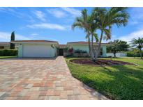 Attractive home with a paved brick driveway and mature landscaping at 9810 San Sebastian Way, Port Richey, FL 34668