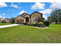 Charming single-story home with well-manicured lawn, mature trees, and a classic two-car garage at 10155 Duffy Cir, Weeki Wachee, FL 34613