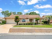 Charming single-story home featuring a well-manicured lawn and an attached two-car garage at 10442 Ventura Dr, Spring Hill, FL 34608