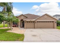 Charming single-story home with a well-manicured lawn and a two-car garage at 2526 Brinley Dr, Trinity, FL 34655
