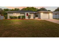 Charming single-story home with well-maintained lawn and a cozy, inviting entrance at 3427 Charmwood Ave, Spring Hill, FL 34609