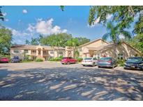 Well maintained two-story condo building with ample parking on a sunny day at 7802 Hardwick Dr # 1116, New Port Richey, FL 34653