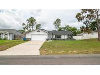 Charming single Gathering home featuring a well-maintained lawn and a concrete driveway at 11494 Villa Rd, Spring Hill, FL 34609