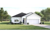 Inviting single-story home featuring a two-car garage and well-manicured front lawn at 20088 Golden Glow Loop, Venice, FL 34292