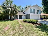 Charming two-story home with well-maintained lawn and landscaping at 3304 Honeymoon Ln, Holiday, FL 34691