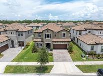 Spacious two-story home featuring a tile roof, well-manicured lawn, and a private two car garage at 4056 Burdick Loop, Odessa, FL 33556