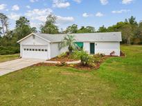 Charming single-story home with well-maintained landscaping and a white exterior at 6197 Belkton Ave, Spring Hill, FL 34608