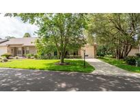 Charming single-story home with a well-manicured lawn and mature trees providing shade at 6620 Brambleleaf Dr, Spring Hill, FL 34606