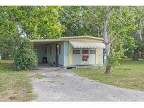 Quaint single-story home with a covered awning and a welcoming entrance at 9401 Bourbon St, New Port Richey, FL 34654