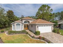 Charming single-story home featuring a well-manicured lawn and a two-car garage at 11404 Inman Ct, Spring Hill, FL 34609