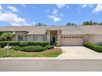 Charming single-story home with a well-maintained lawn and a two-car garage in a quiet neighborhood at 1142 Wolford Dr, Trinity, FL 34655