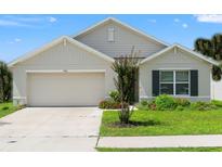 Charming one-story home with a well-maintained lawn and inviting two-car garage, providing curb appeal at 3900 Autumn Amber Dr, Spring Hill, FL 34609