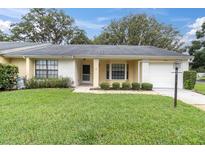 Charming single-story home with well-manicured lawn and inviting front entrance with brick accents and an attached garage at 4841 Wakefield Ct # 4841, New Port Richey, FL 34655